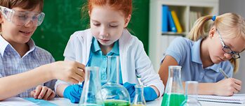 Three children experimenting in class.