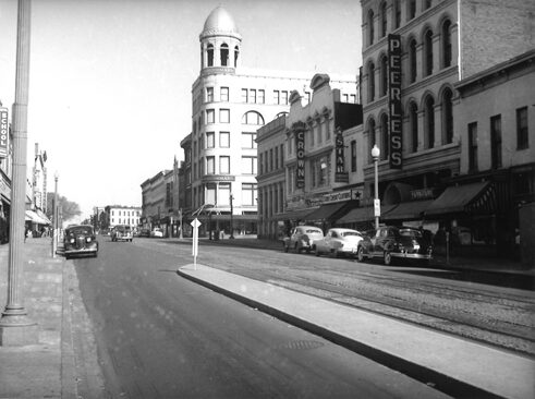 East Side of 7th Street Looking North from H Street NW. The street as it looked on October 23, 1949. Julius Germuiller's building at 819-821, once Grogan's Furniture, has become Peerless Furniture by 1949.	