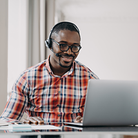 Man sitting at desk with books and computer