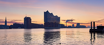 Atmospheric picture of Hamburg harbour and the Elbphilharmonie concert hall at sunrise.
