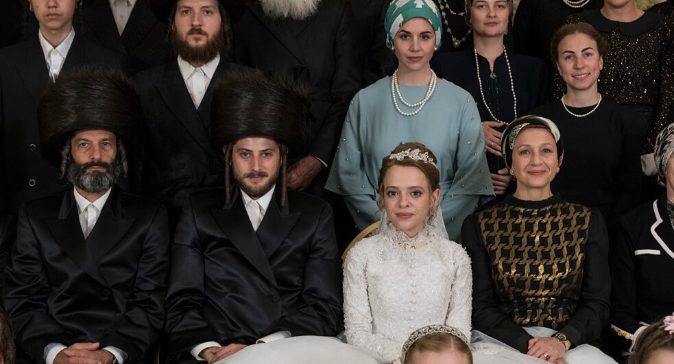 Yanky (Amit Rahav) and Esty (Shira Haas) amidst their families at their wedding.