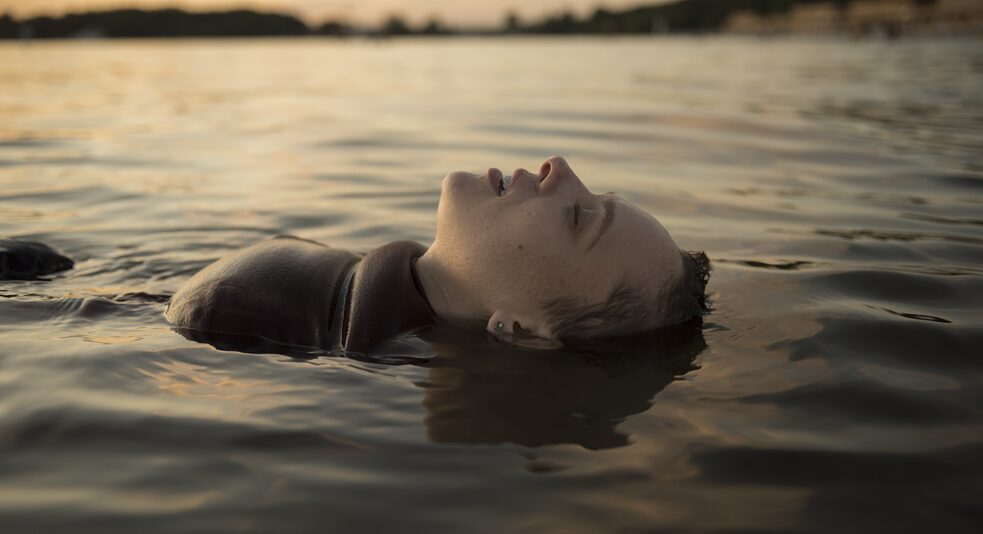  Esty floating on her back in the lake